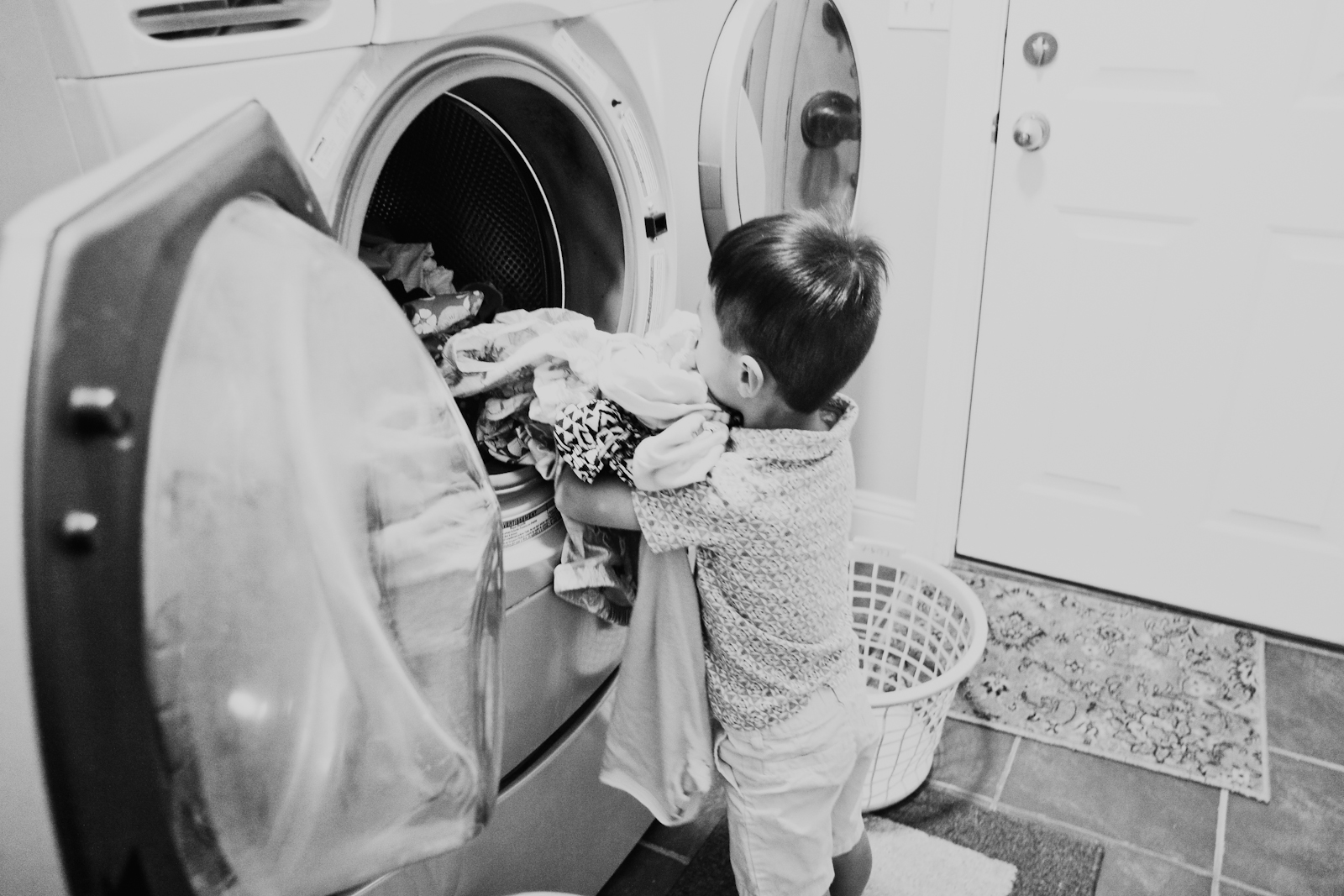 Toddler helping with laundry